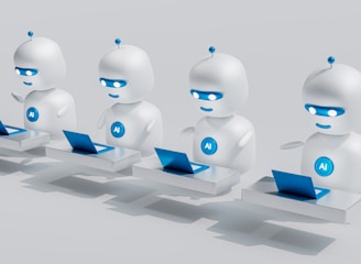 Four small, white robot figures are sitting in a row, each with a laptop in front of them. They have round bodies and blue accents, with 'AI' displayed on their chests. The background is minimal and light gray, emphasizing the robots and their computers.