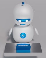 A small, white humanoid robot with blue accents, including eyes, mouth, and a circular badge with the letters 'AI' on its chest, is positioned in front of a blue laptop on a metallic surface. The robot has a simple, smooth design with two cylindrical arms and a small antenna on top.
