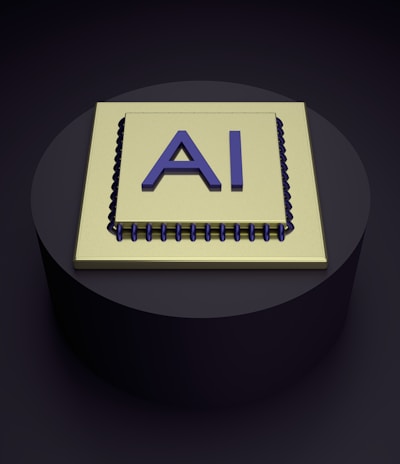 A 3D rendering of a microchip with the letters 'AI' prominently displayed on its surface, set on a dark, circular platform.