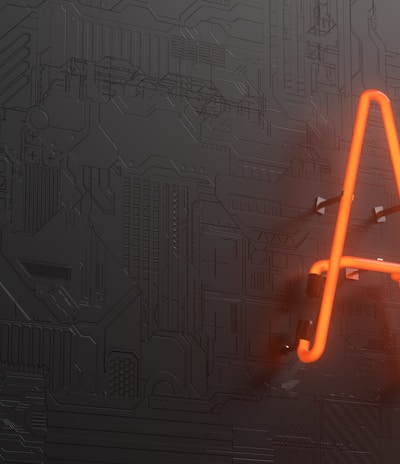A glowing neon sign displaying the letters 'AI' is mounted on a dark, textured wall that resembles a circuit board or technological pattern.